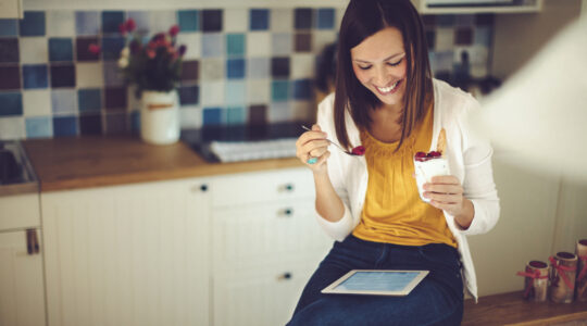 Woman eating healthy snack at work